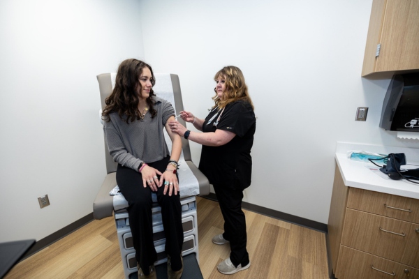 A student and clinician in a health appointment. 