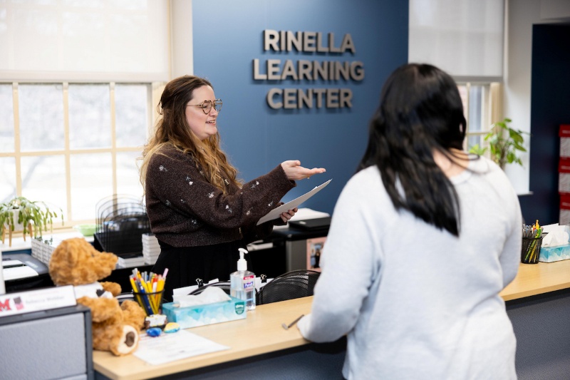 A student checking in at the Rinella Learning Center office.