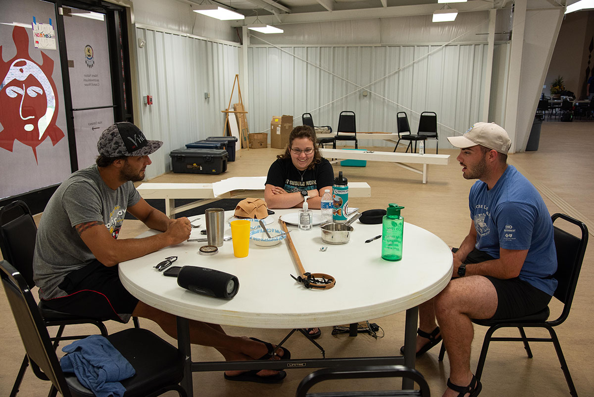 Three students sit around a table at the Miami Tribe of Oklahoma's headquarters during a summer camp youth program