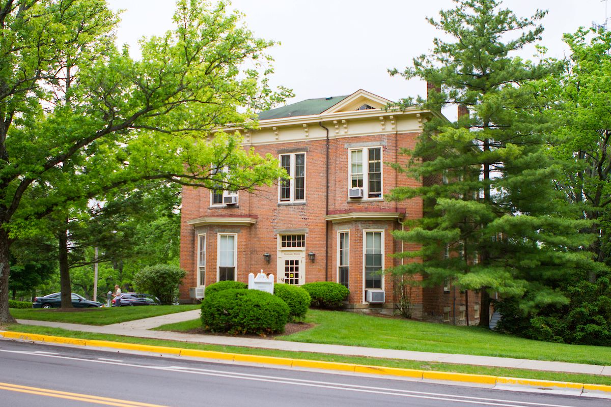 Bonham House's red brick exterior surrounded by trees