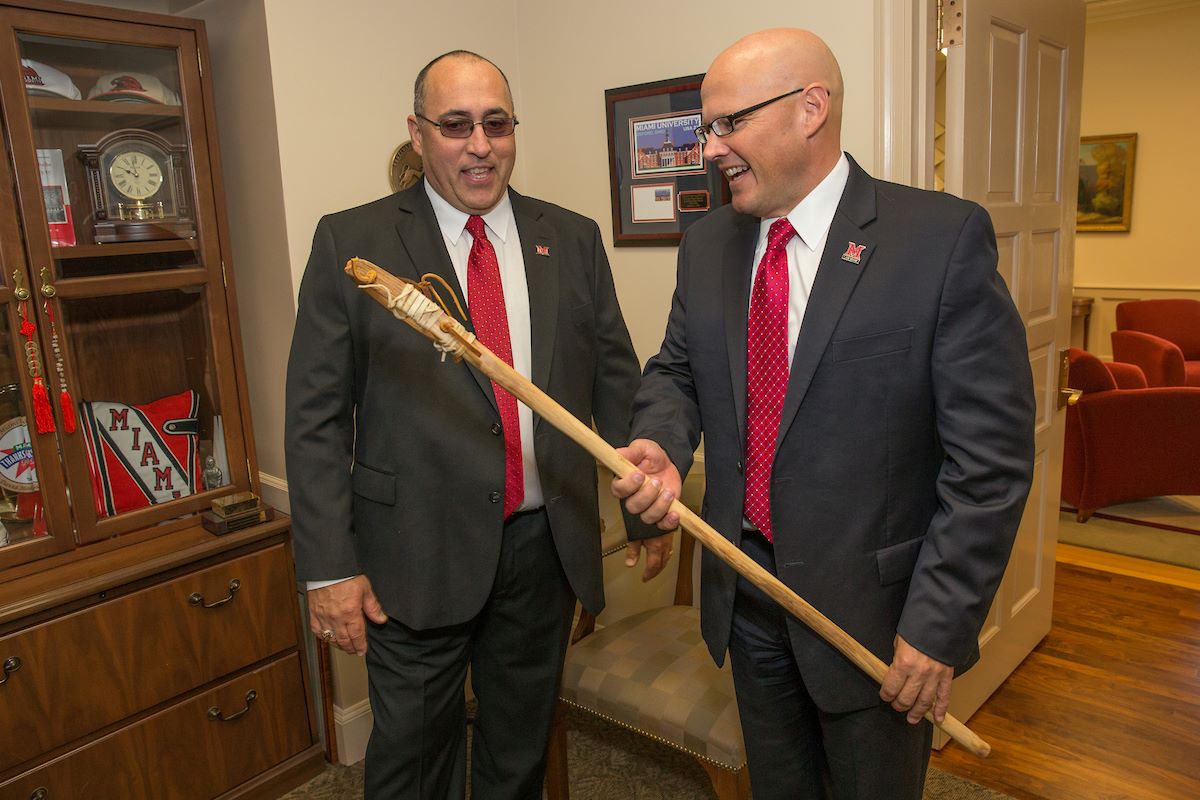 Chief Lankford and President Crawford holding a traditional myaamia lacross stick