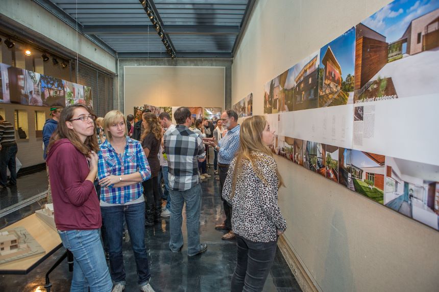 Students view an art exhibition at Cage Gallery.