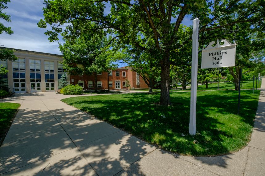 Phillips Hall with trees in the foreground.