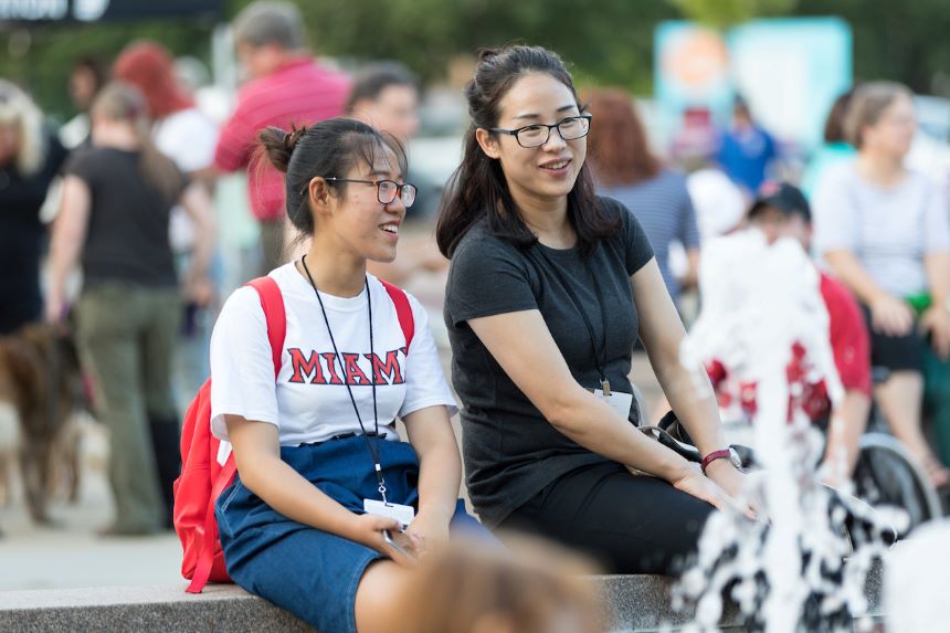 Two students enjoy an international music festival.