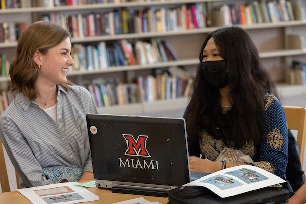 Two students working together at the library