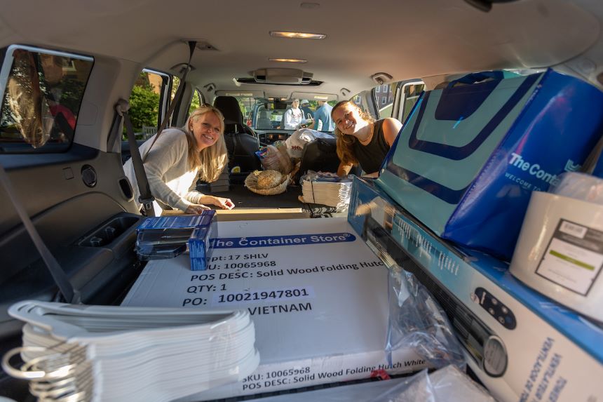 Parent and student look in the car as they prepare to move the student in.