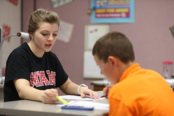 A Miami student teaching a Talawanda student in class