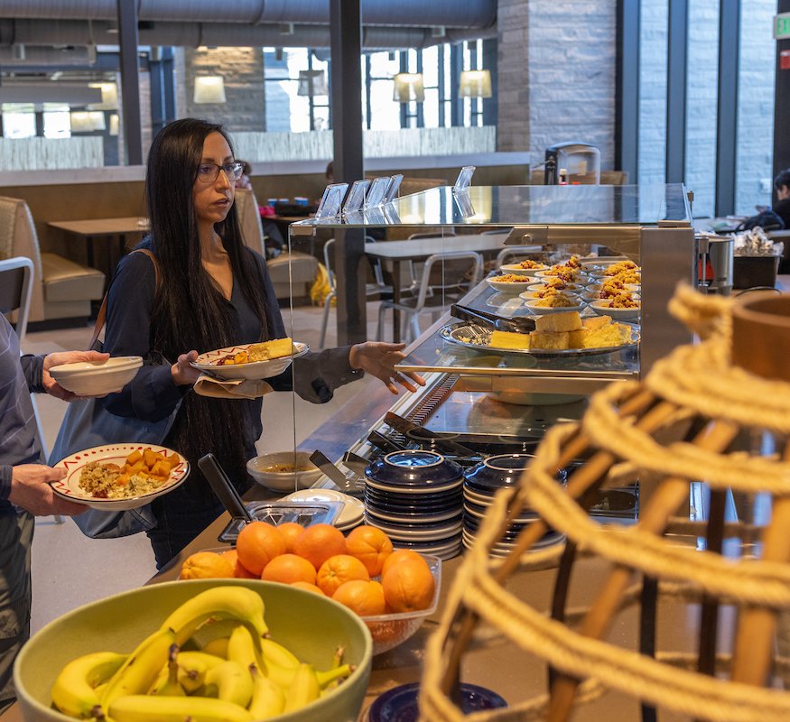 A staff member in line at a buffet dining location