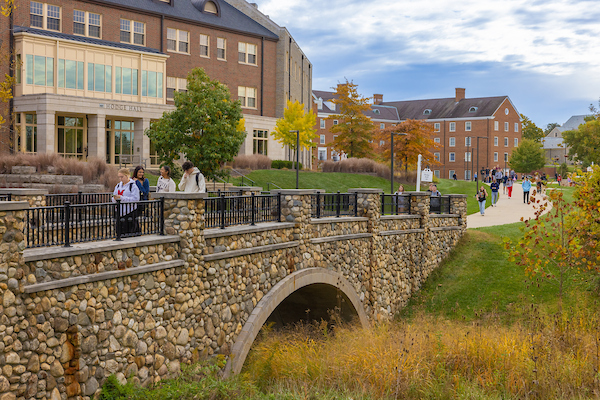 Students crossing a bridge on campus