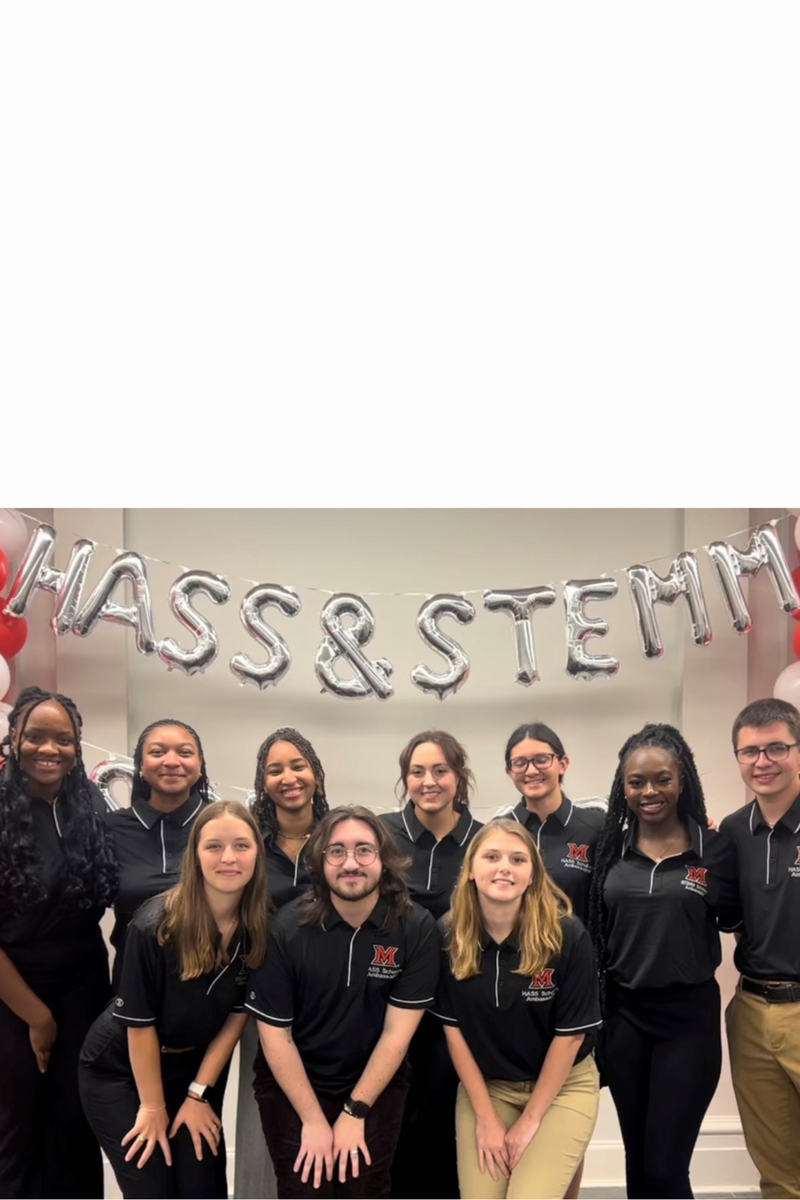 Group photo of 10 HASS scholar ambassadors, under silver balloon letters that spell HASS & STEMM
