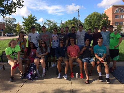 About 20 incomingMiami students wearing shorts and posing on campus on a nice day.