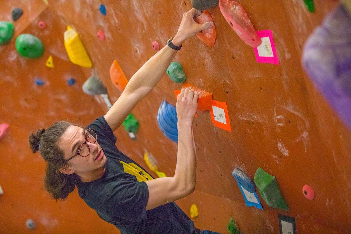 A student climbing the rock wall at Miami's Outdoor Pursuit Center