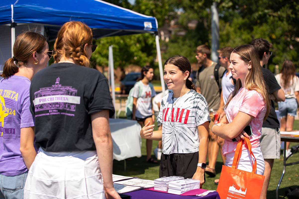 Members of a student organization introducing potential new members to their group at Mega Fair