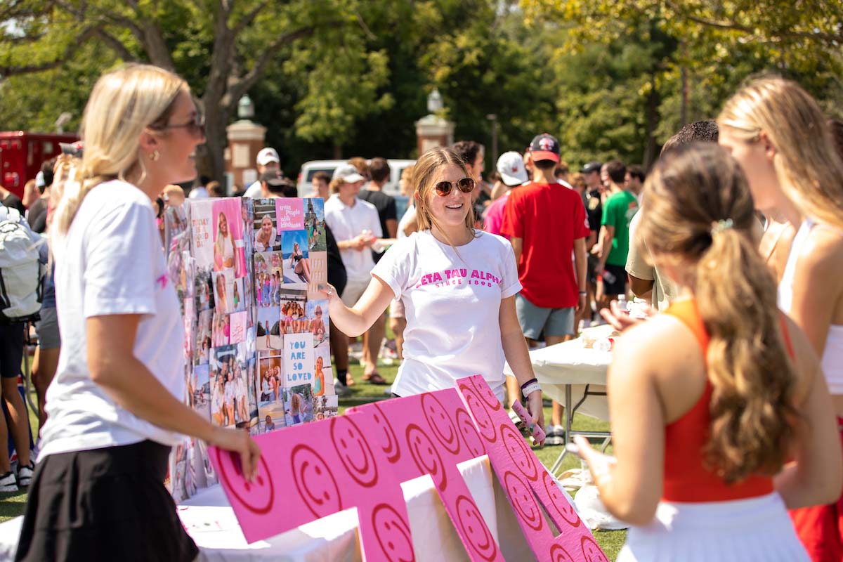 Students in a sorority talk to students during Rush Week