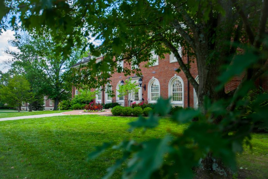 Warfield Hall with trees in the foreground.