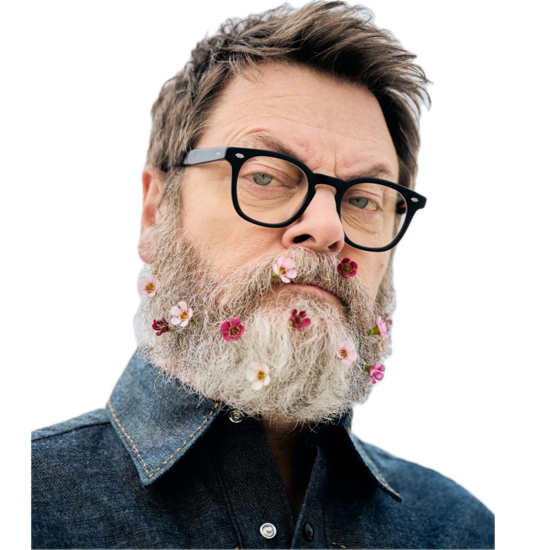 Nick Offerman with small pink and red flowers peppering his gray beard. 