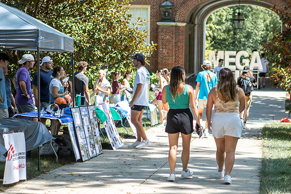 students walking at mega fair with groups tabling