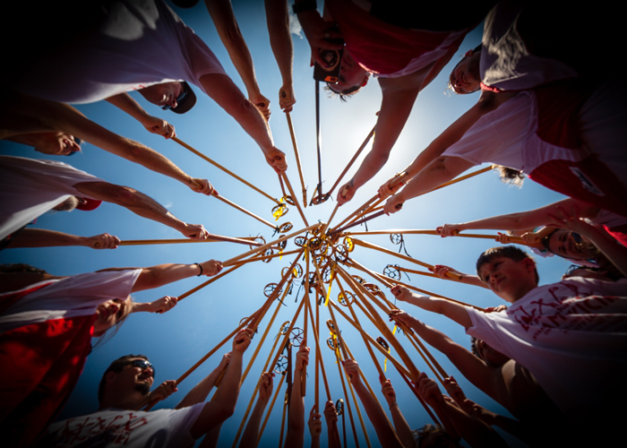 a group of people gathered in a circle holding various commemorative objects