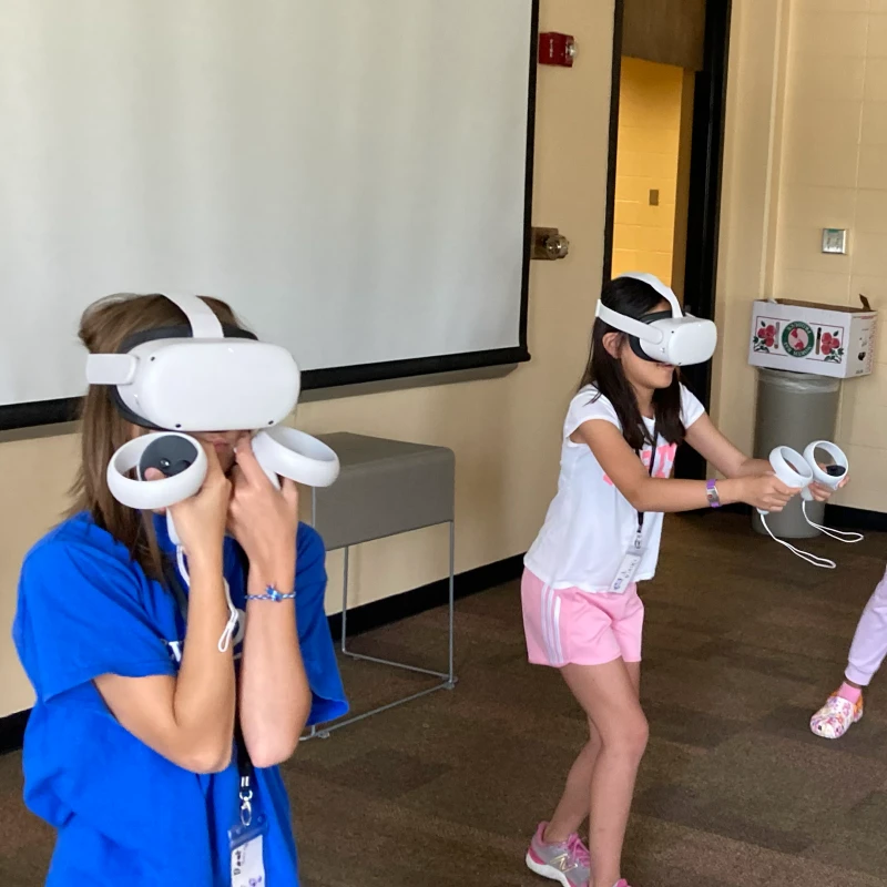 STEAM Studio campers playing a game with VR headsets.