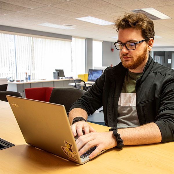 An adult learner working on his computer.