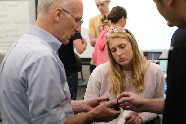 Students in lab with professor.