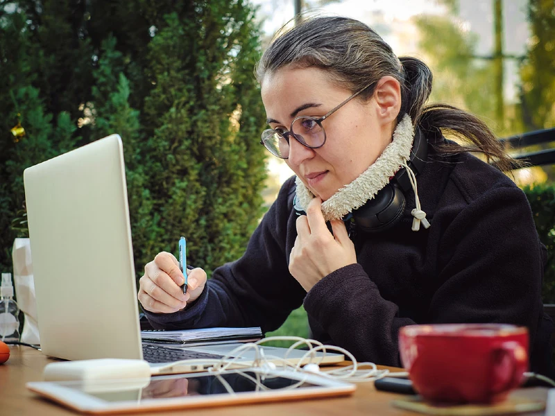 A female student working with a laptop computer.