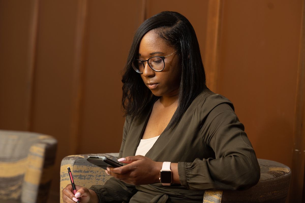 Master of Business Administration student using her mobile device.