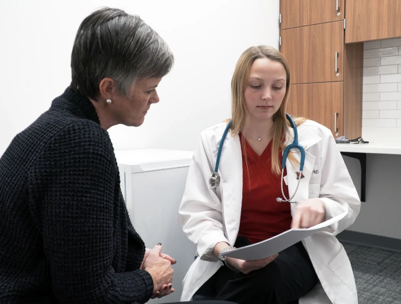 MSN Family Nurse Practitioner student working with the Associate Provost in a healthcare office setting.