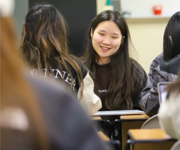 A international student smiling during class.