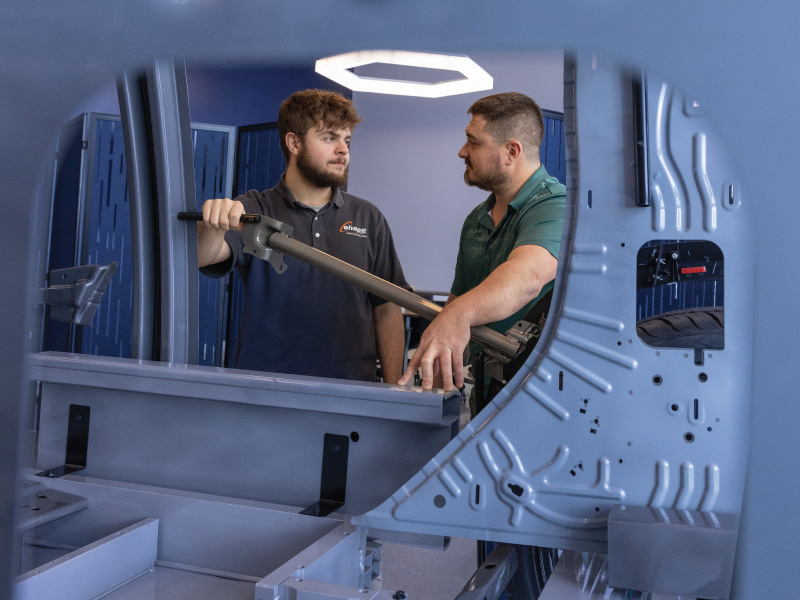 Work+ Student Xavier and his supervisor at Shape talking about a piece of aluminum. 