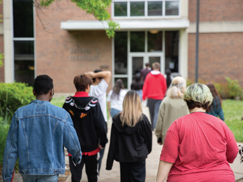 The back of a group of students heads taking a tour of Miami Regionals Middletown campus.