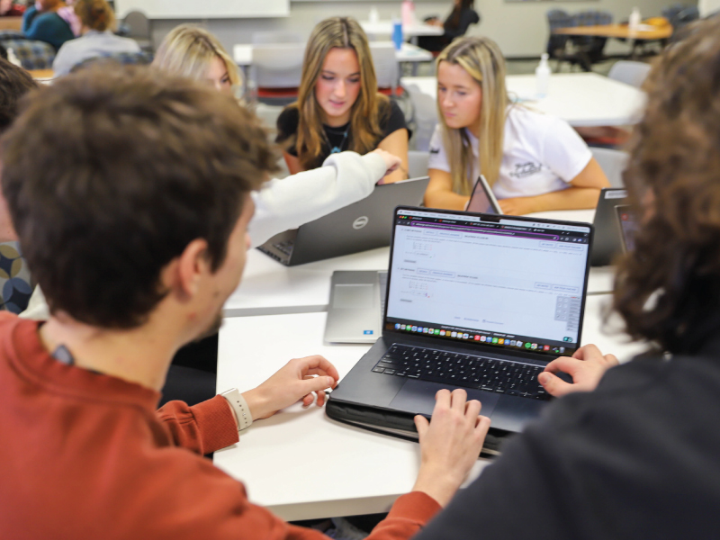 ECA students working on their laptops in their classroom on campus.