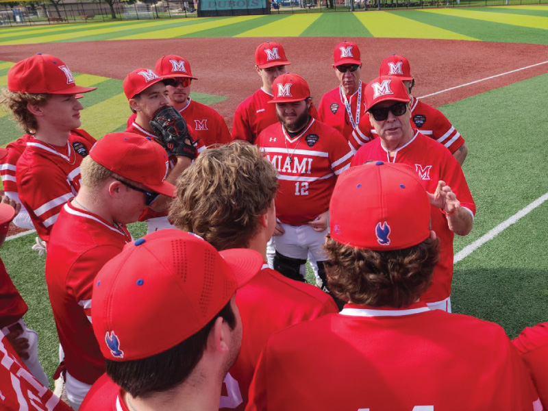 2025 Thunderhawk Baseball Team in a huddle listening to their coach Mark Adams.