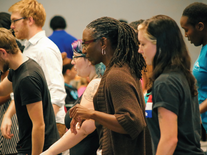 Dr. Bennyce Hamilton dancing with a group of students.