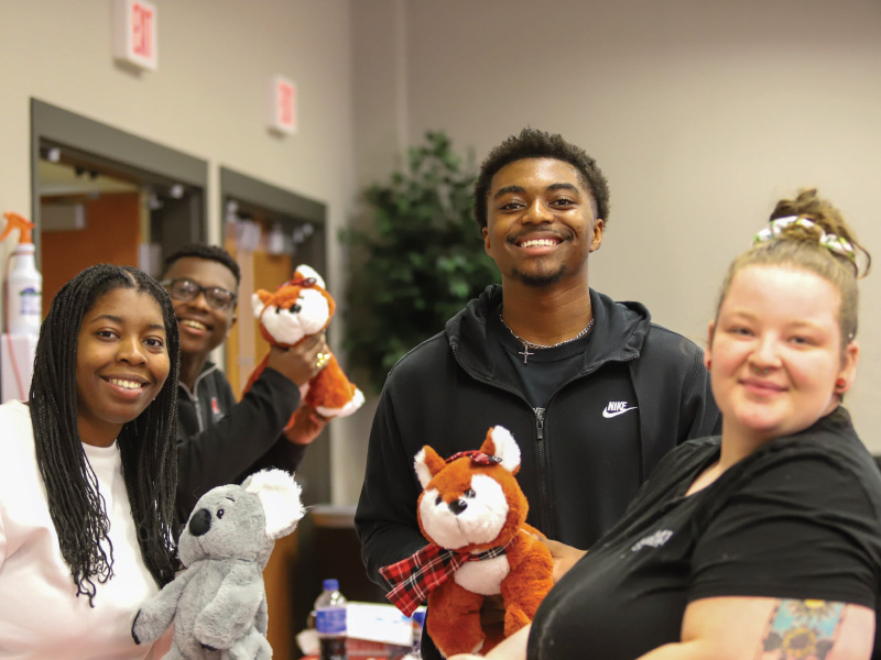 Students holding stuffed animals during Spring Fling
