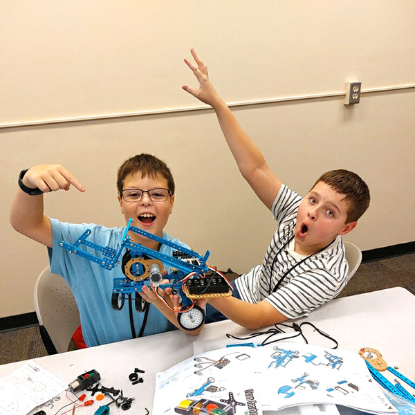 Campers showing the robot that they built