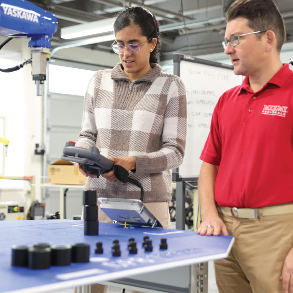 A student and instructor in the Robotics Lab.
