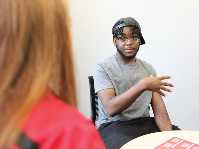 Student meeting one on one with his advisor.