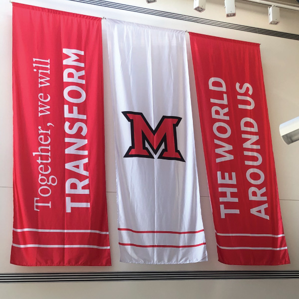 Middletown Campus levey hall red and white banners hanging from the wall with Together, We Will Transform branding. 