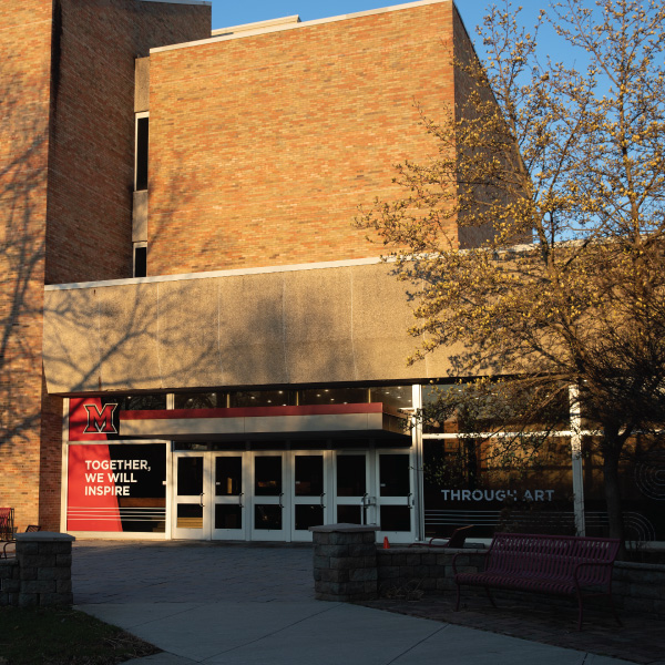 Hamilton campus Phelps hall exterior with Together, We Will Transform through Art branding.