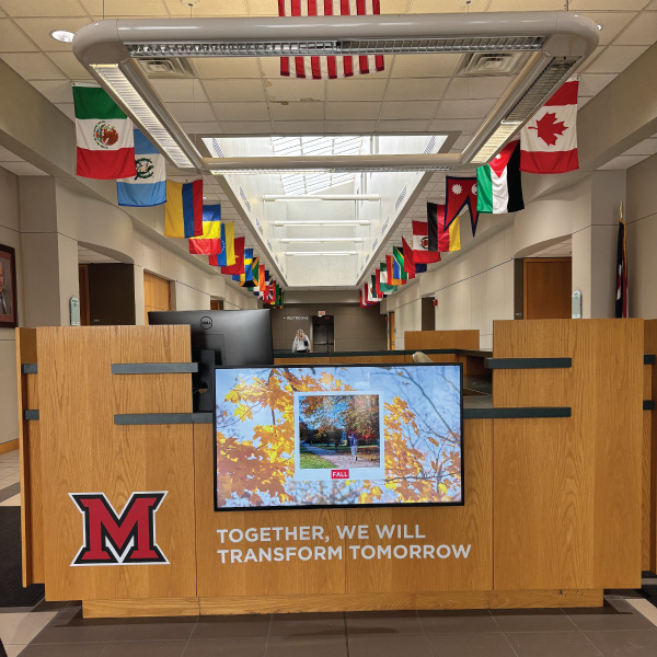 Hamilton Campus Harry T. Wilks conference center desk entrance with "Together, WE will" branding. 