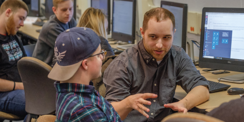 2 students talking in a classroom