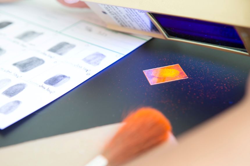 Forensic science lab materials and a fingerprint.