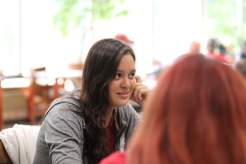 Student talks with other students in class.