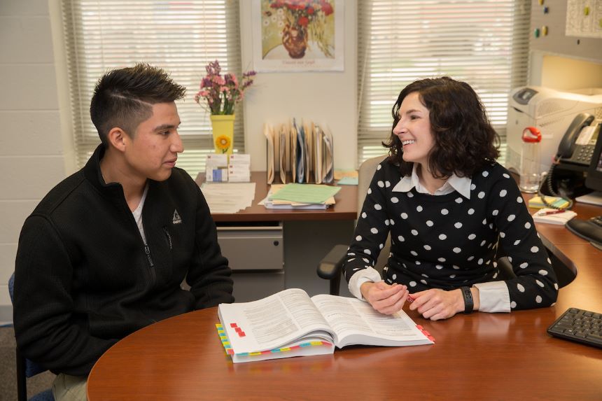 Student talks with their advisor.