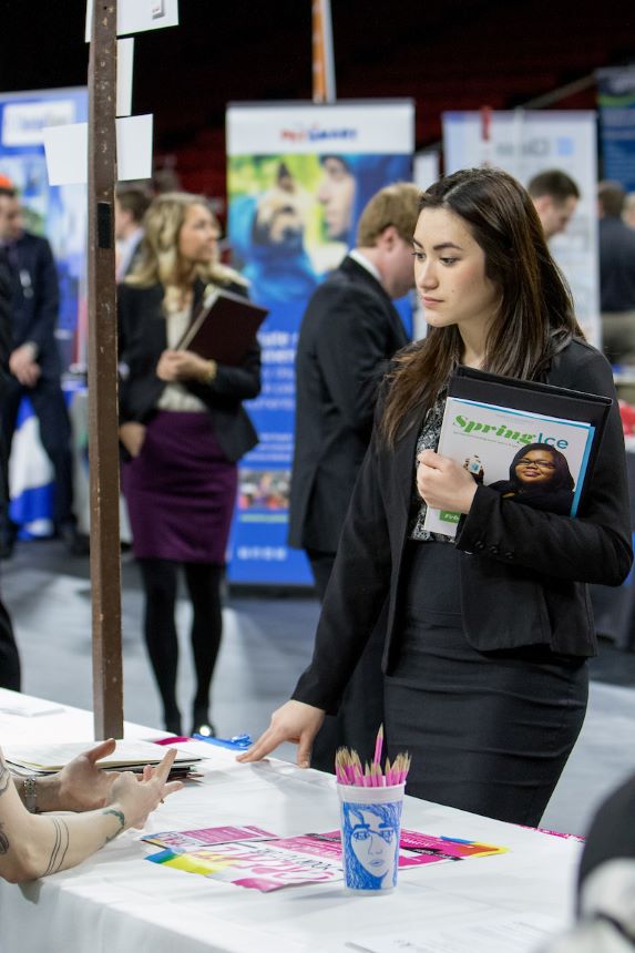Student talks with a potential employer at a career fair.