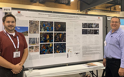 Trevor Lambert and Dr. Krekeler stand in front of Trevor's geology poster presentation.