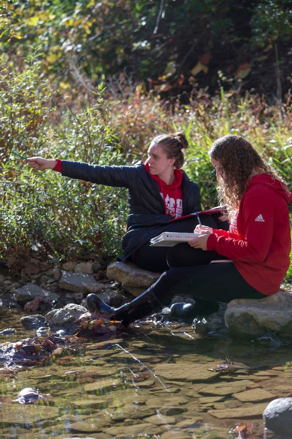 Two students outide for geology class.