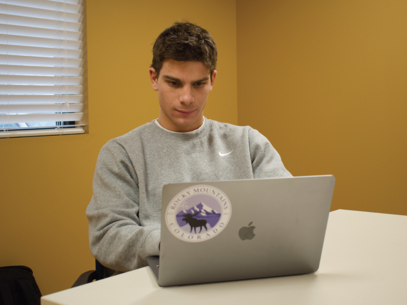 Aiden Brillhart working on his laptop.