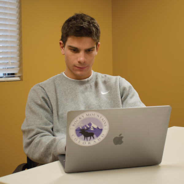 Aiden Brillhart working on his laptop.